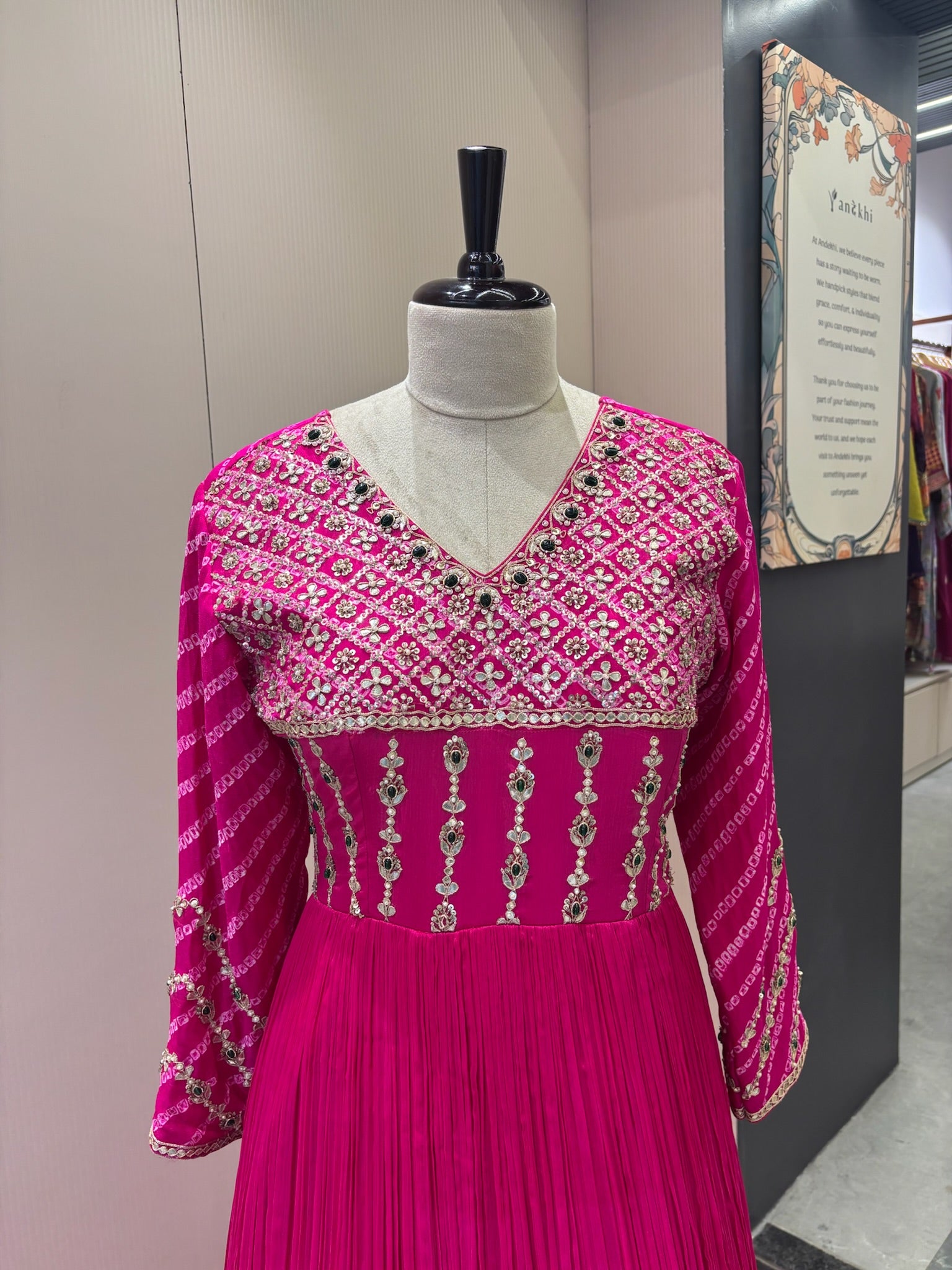 A1282 - A Fuchsia Pink crepe gown with bandhani yoke, gota work, and bead detailing with a graceful flare.