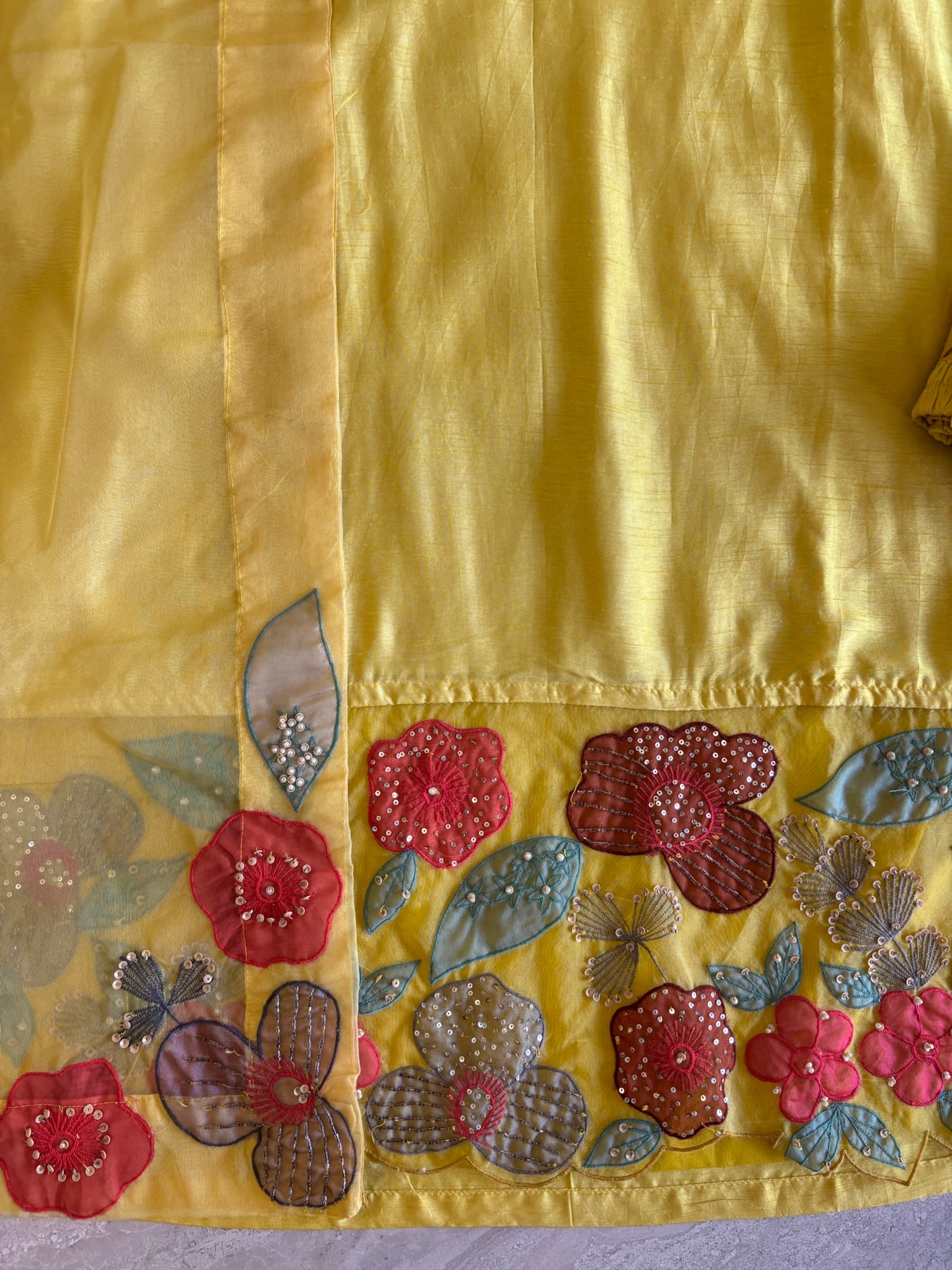 A1558- Premium Dola Silk Suit with intricate Organza Appliqué Patchwork & Handwork detailing, paired with matching Pants & Dupatta.