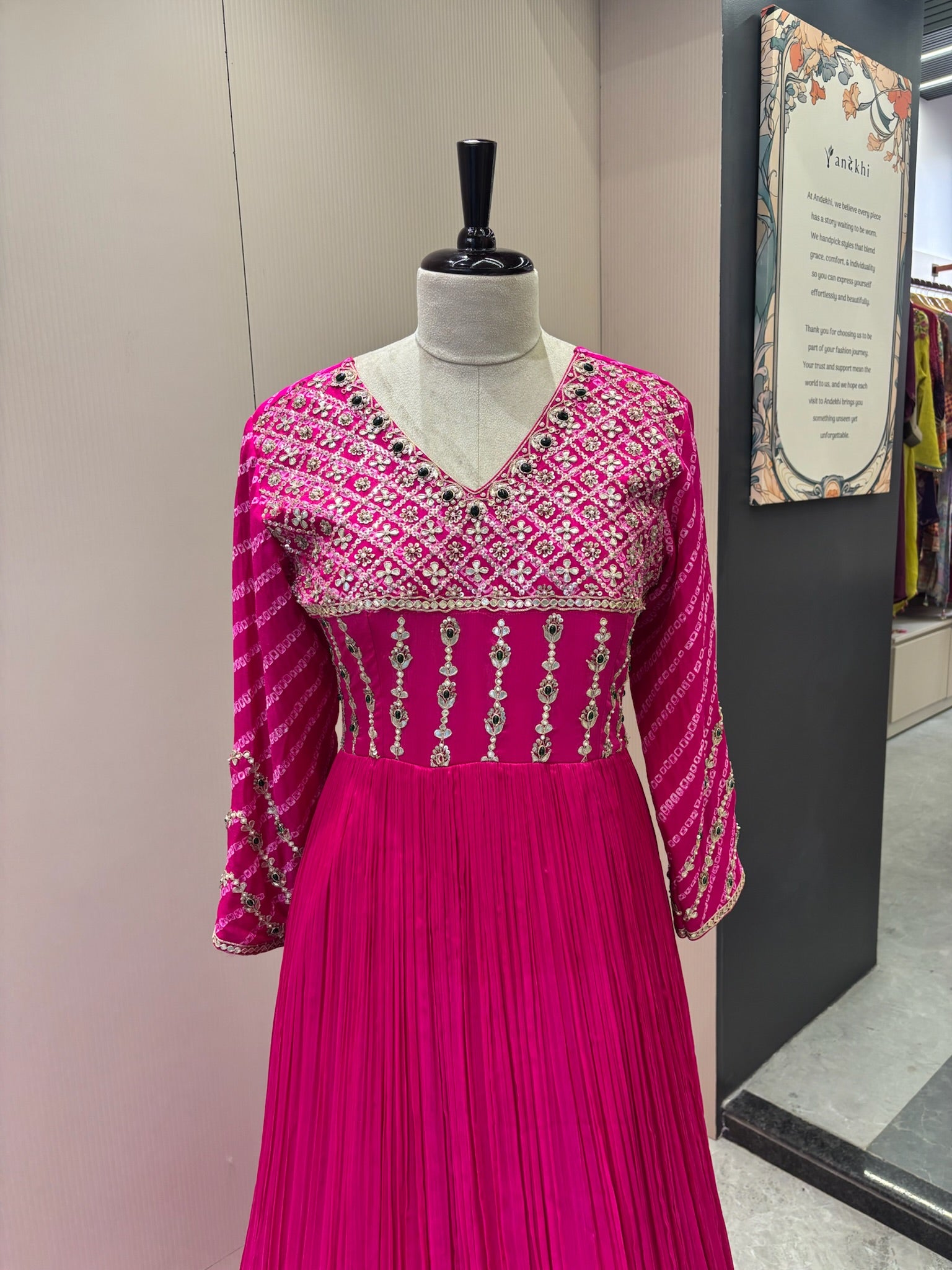 A1282 - A Fuchsia Pink crepe gown with bandhani yoke, gota work, and bead detailing with a graceful flare.