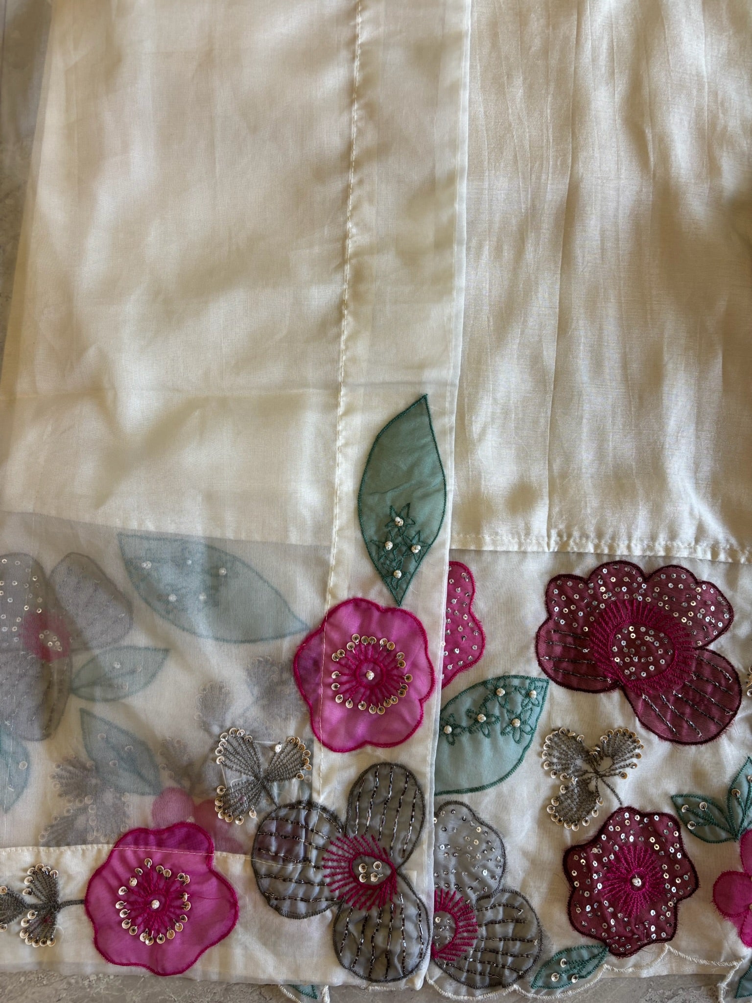 A1558- Premium Dola Silk Suit with intricate Organza Appliqué Patchwork & Handwork detailing, paired with matching Pants & Dupatta.