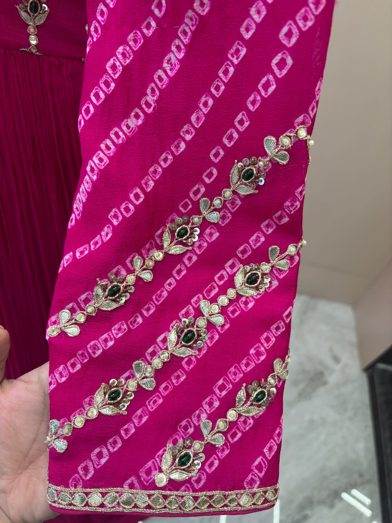 A1282 - A Fuchsia Pink crepe gown with bandhani yoke, gota work, and bead detailing with a graceful flare.
