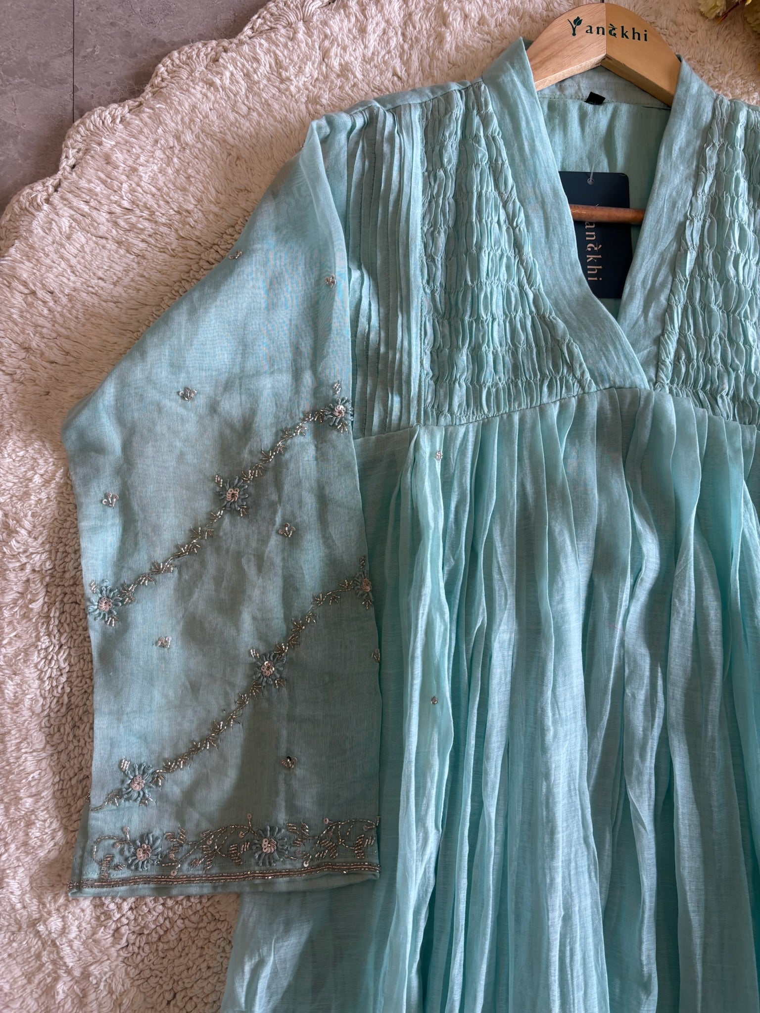 A4154- Pure Mul Chanderi Suit featuring delicate Handwork on the Sleeves, elegant Smocking on the Yoke, & a graceful Flowy Dupatta.