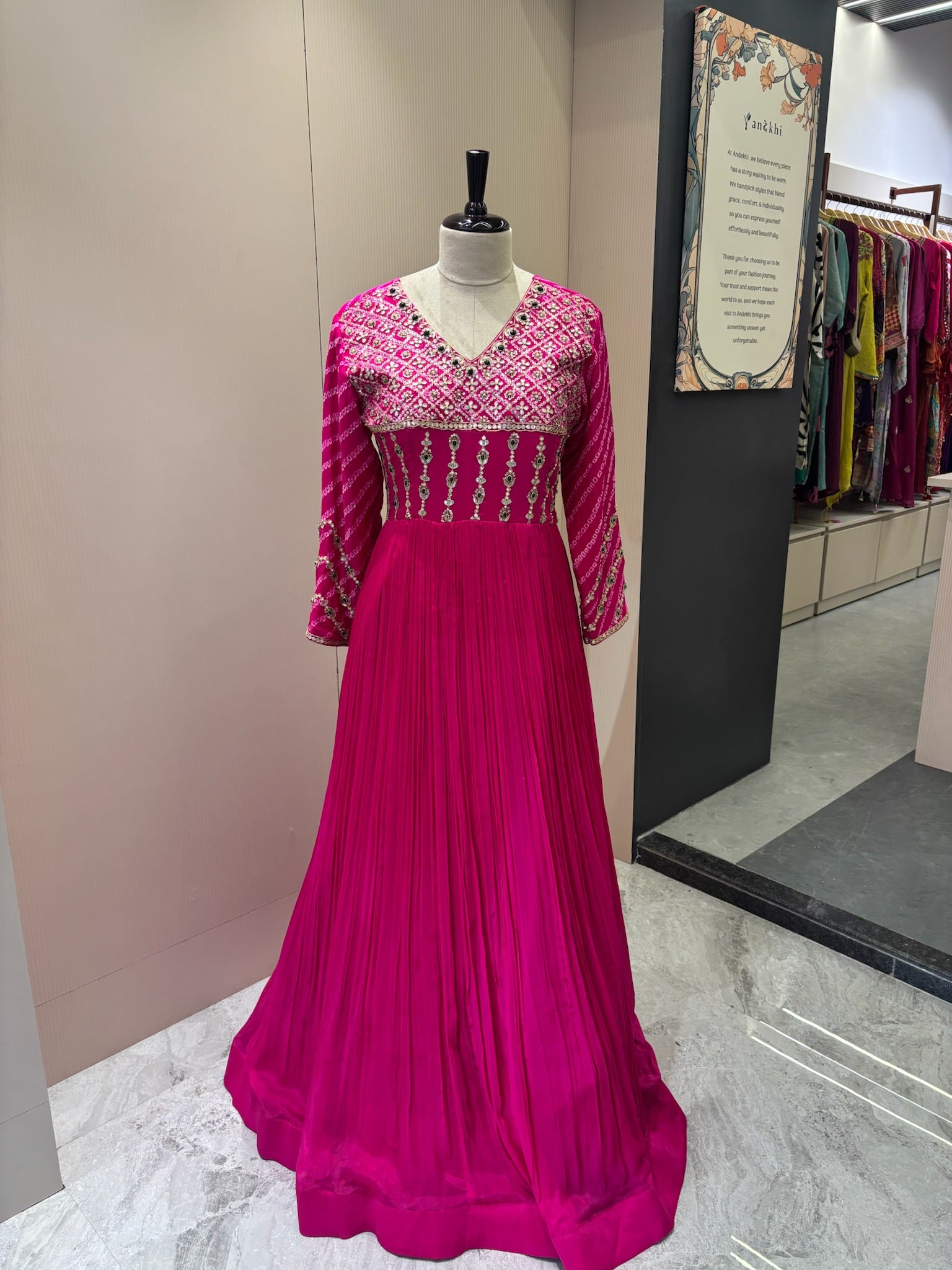 A1282 - A Fuchsia Pink crepe gown with bandhani yoke, gota work, and bead detailing with a graceful flare.