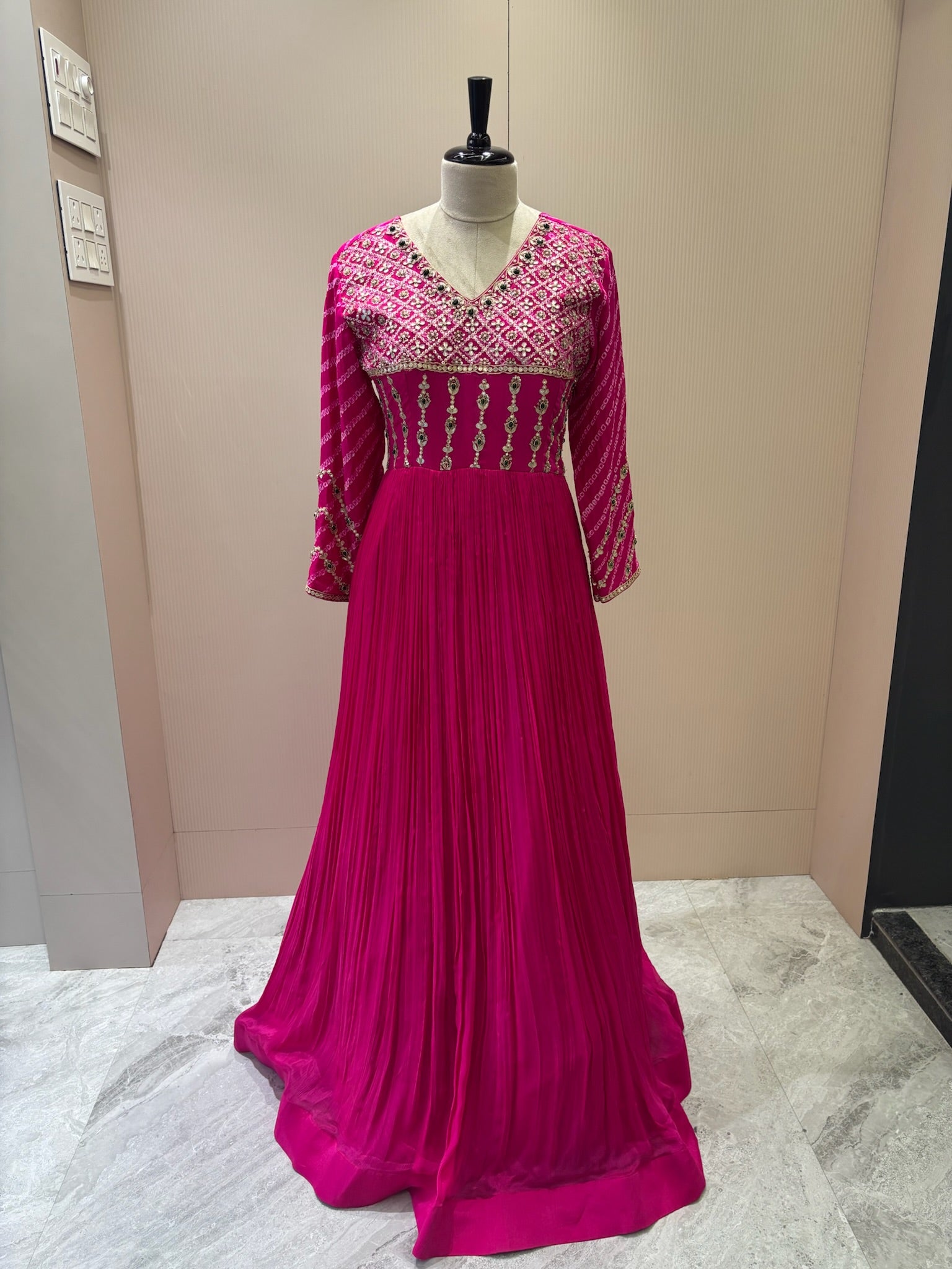 A1282 - A Fuchsia Pink crepe gown with bandhani yoke, gota work, and bead detailing with a graceful flare.