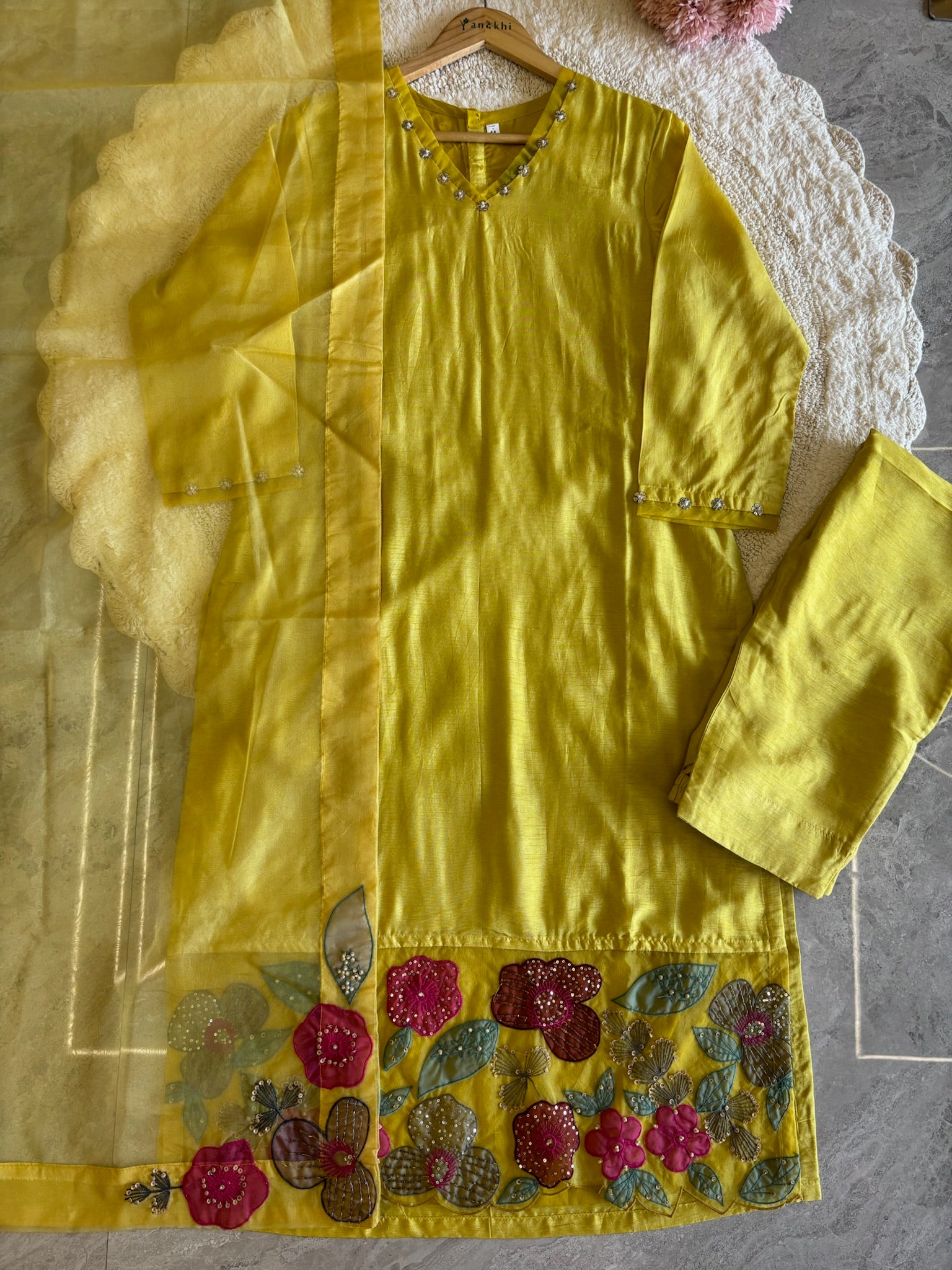 A1558- Premium Dola Silk Suit with intricate Organza Appliqué Patchwork & Handwork detailing, paired with matching Pants & Dupatta.