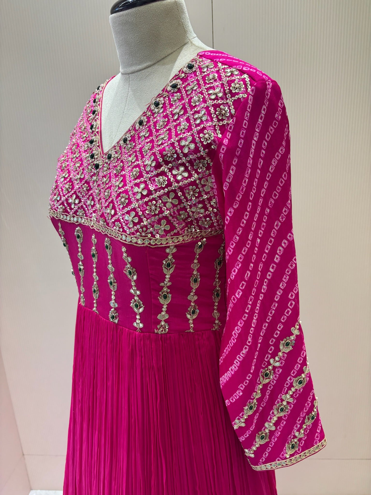 A1282 - A Fuchsia Pink crepe gown with bandhani yoke, gota work, and bead detailing with a graceful flare.