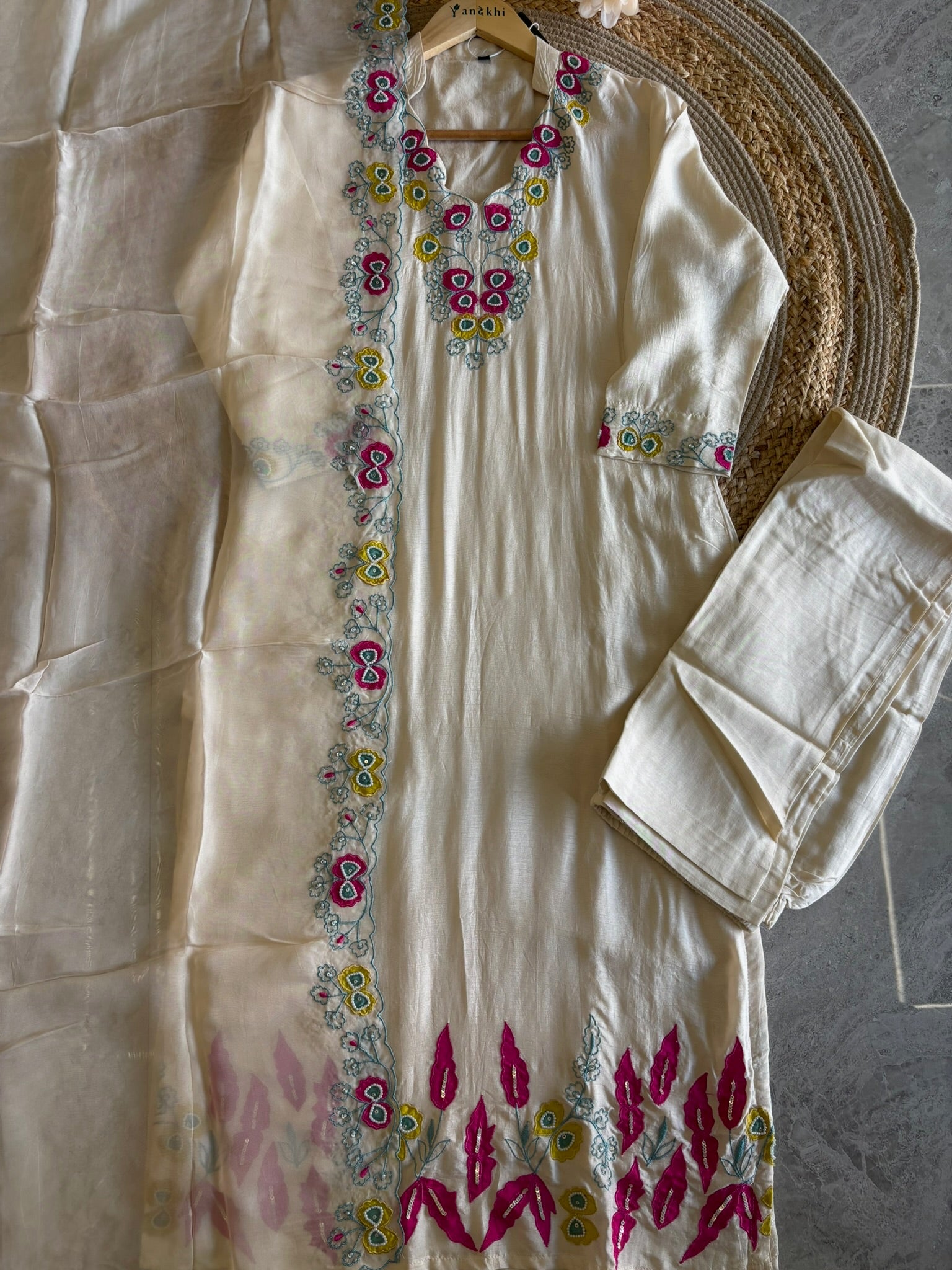 A1552- Pure Silk Suit featuring Appliqué Patchwork & delicate Handwork detailing, paired with Pants & a sheer Pure Organza Dupatta.
